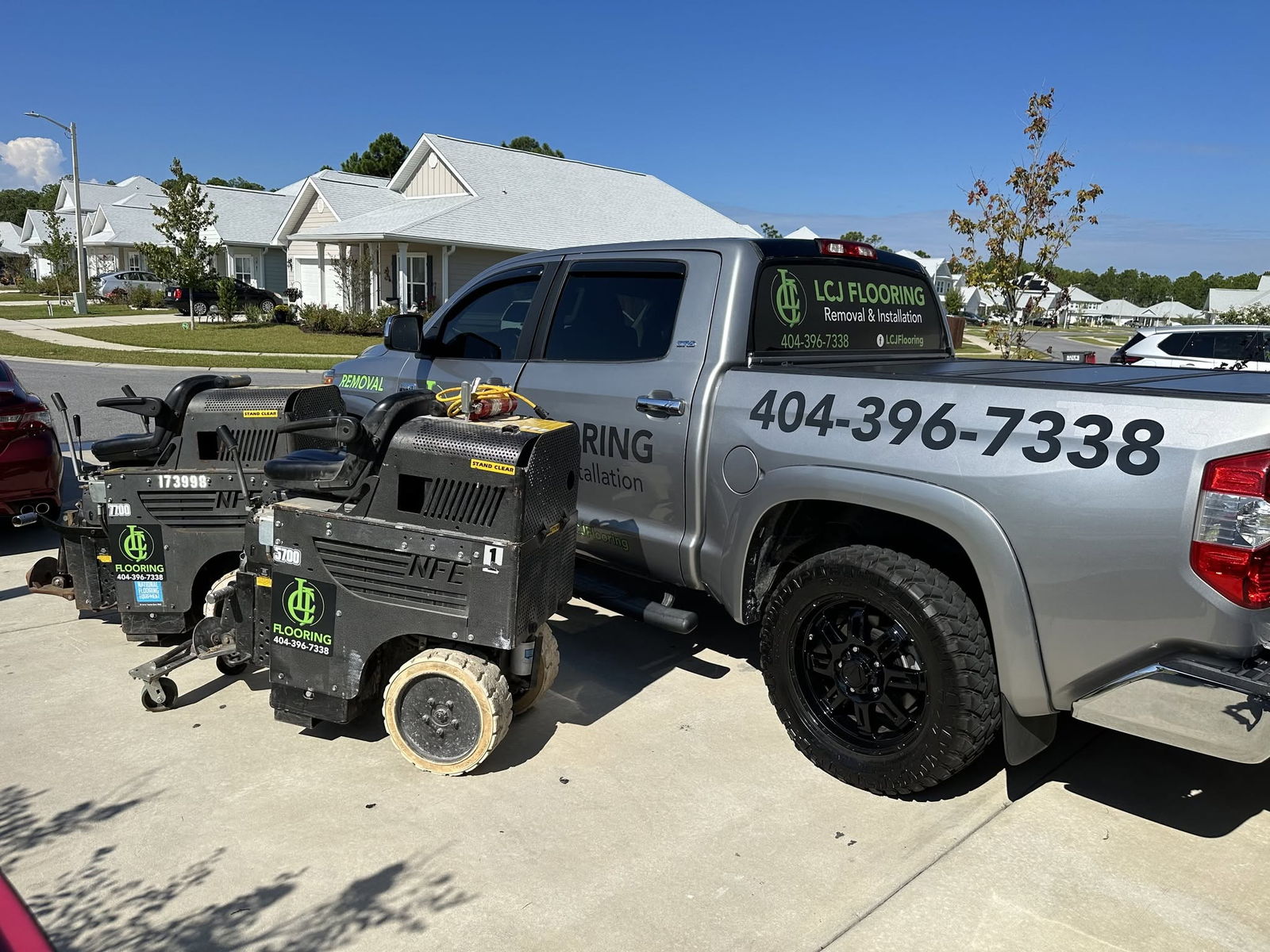 LCJ Flooring truck and professional floor removal machines on a residential job site